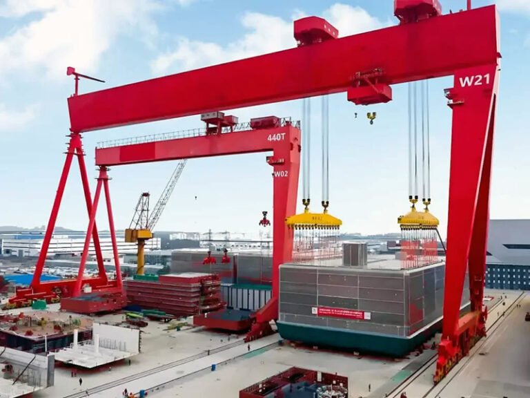 Large red gantry crane at shipyard